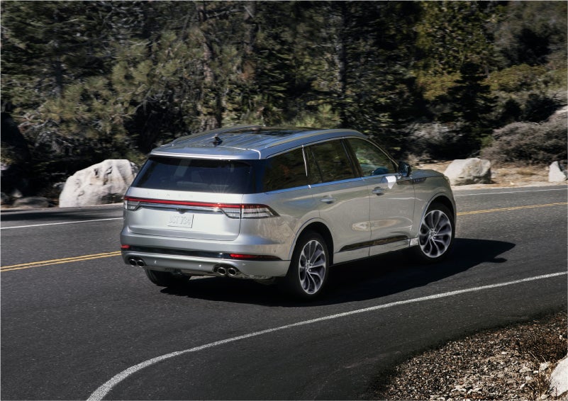 A 2023 Lincoln Aviator® Grand Touring model is shown being driven on a tight turn of a mountain road | Gray-Daniels Lincoln in Brandon MS