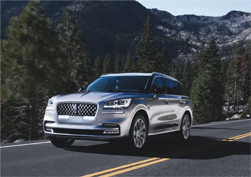 A 2023 Lincoln Aviator® Grand Touring SUV being driven on a winding road to demonstrate the capabilities of all-wheel drive | Gray-Daniels Lincoln in Brandon MS
