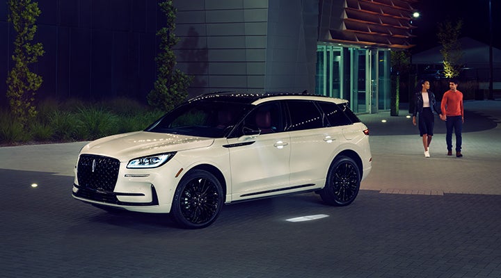 Two people approach a 2024 Lincoln Corsair® SUV featuring the available Jet Appearance Package. | Gray-Daniels Lincoln in Brandon MS