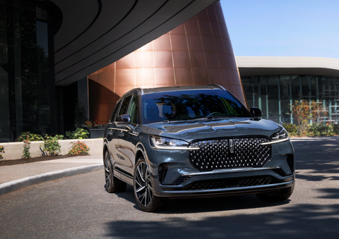 A gray 2025 Lincoln Aviator® SUV is parked outside a modern building with the sun shining. | Gray-Daniels Lincoln in Brandon MS