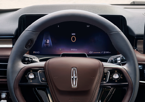 The steering wheel of 2025 Lincoln Aviator® SUV is shown with black and brown accents. | Gray-Daniels Lincoln in Brandon MS