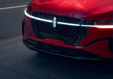 The available front LED light bar and center Lincoln Star logo glow at dusk. | Gray-Daniels Lincoln in Brandon MS