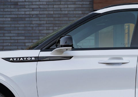 The driver’s side door and fender badging of a white 2026 Lincoln Aviator® SUV are showcased. | Gray-Daniels Lincoln in Brandon MS