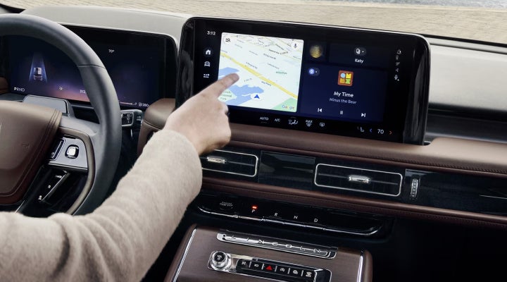 A person is tapping the center display touchscreen of a 2026 Lincoln Aviator® SUV. | Gray-Daniels Lincoln in Brandon MS