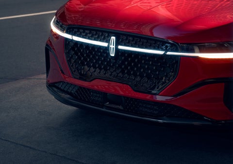 The available front LED light bar and center Lincoln Star logo glow at dusk. | Gray-Daniels Lincoln in Brandon MS