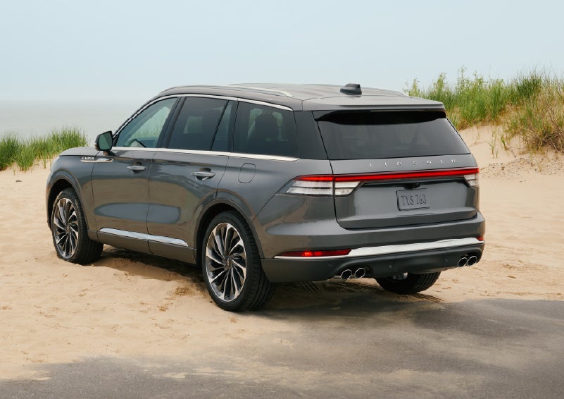 A 2027 Lincoln Aviator® SUV is parked next to sand dunes. | Gray-Daniels Lincoln in Brandon MS