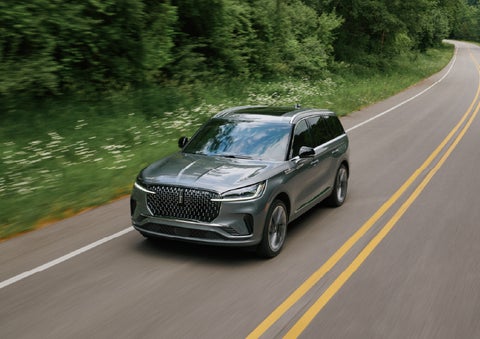 A 2027 Lincoln Aviator® SUV is being driven down a road. | Gray-Daniels Lincoln in Brandon MS