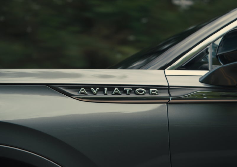 The driver’s side door and fender badging of a gray 2027 Lincoln Aviator® SUV are showcased. | Gray-Daniels Lincoln in Brandon MS