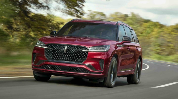 A 2027 Lincoln Aviator® SUV is being driven on a country road | Gray-Daniels Lincoln in Brandon MS