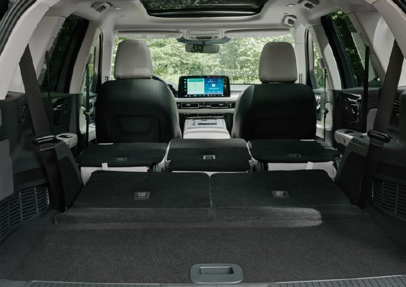 A rear to front view of the interior of a 2027 Lincoln Aviator® Black Label™ SUV shows the third and second rows folded flat | Gray-Daniels Lincoln in Brandon MS