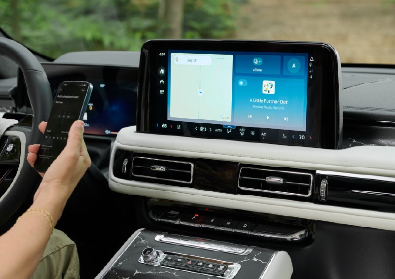 A person pairs thier phone with the center touchscreen of a 2027 Lincoln Aviator® Black Label™ SUV | Gray-Daniels Lincoln in Brandon MS